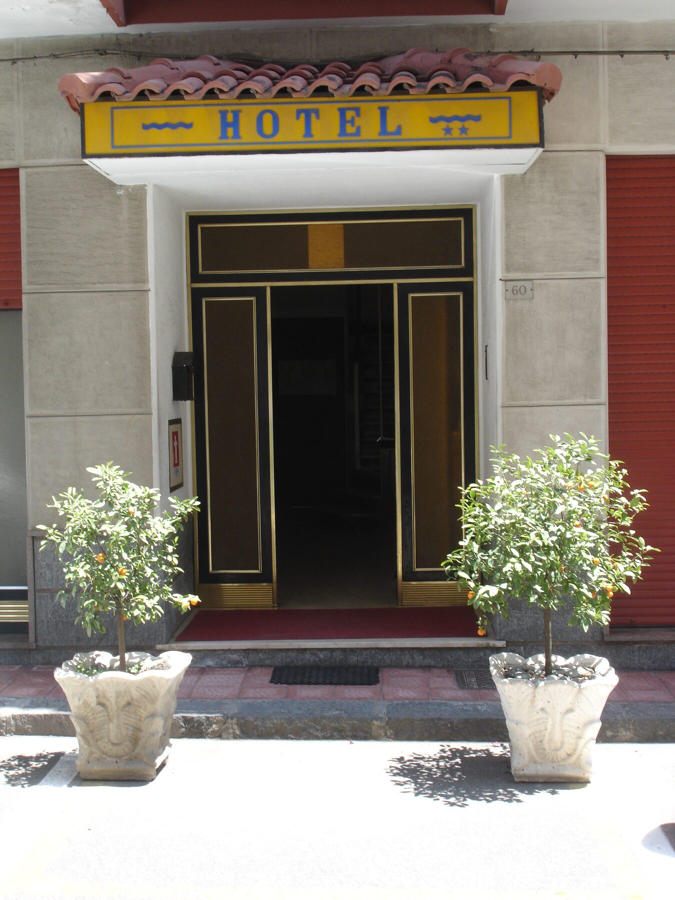 Entrance of Hotel La Rusticana with sign